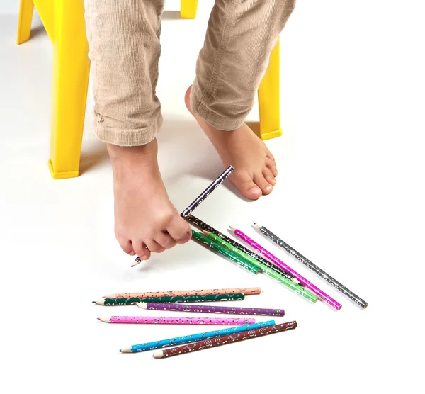 Child's feet performing gymnastic with pencils — Stock Photo, Image