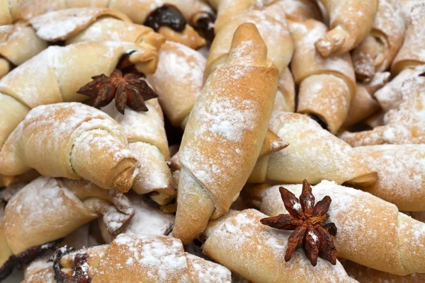 Freshly baked croissants with powdered sugar. — Stock Photo, Image