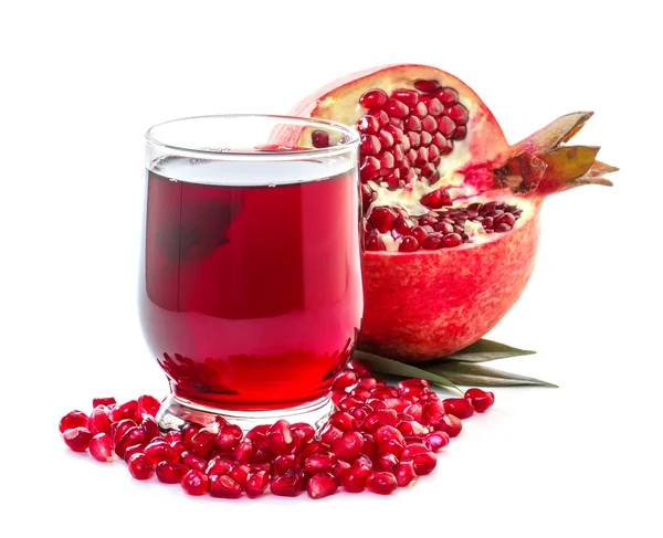 Ripe pomegranate and glass of juice on a white background — Stock Photo, Image