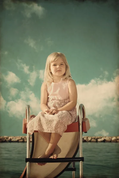 Sahilde küçük bir kız. stilize eski fotoğraf — Stok fotoğraf