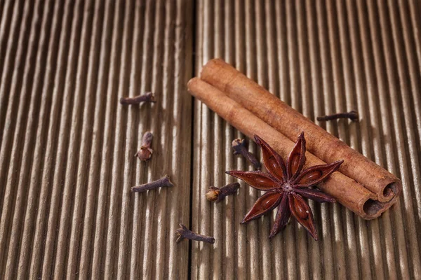 Cinnamon with anise on a wooden background — Stock Photo, Image