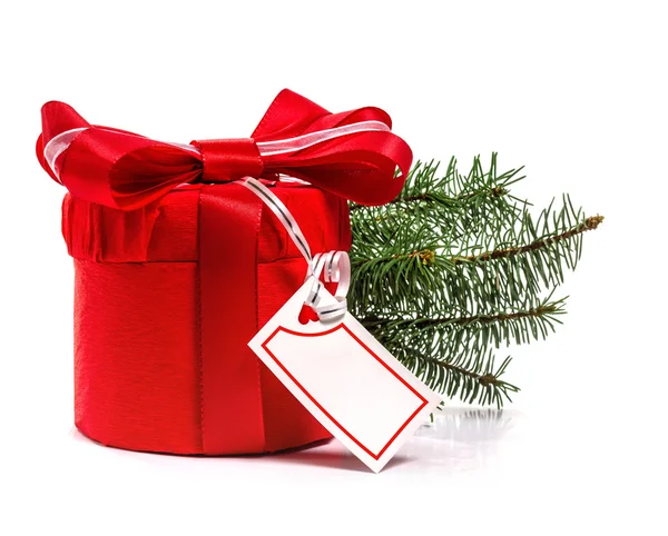 Red gift with Christmas tree branch. Isolate on white background — Stock Photo, Image