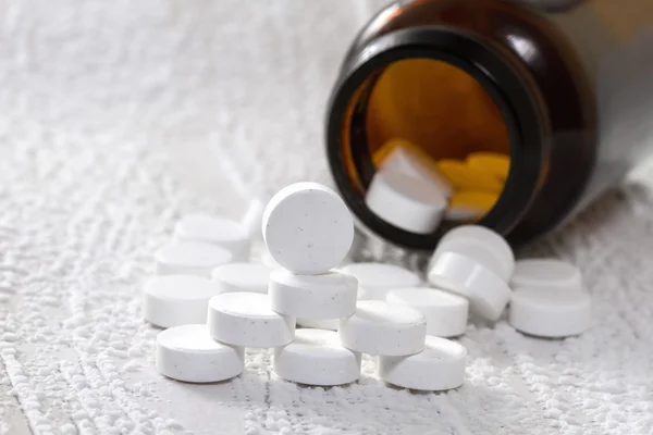 Pills in medical bottle on the table. — Stock Photo, Image