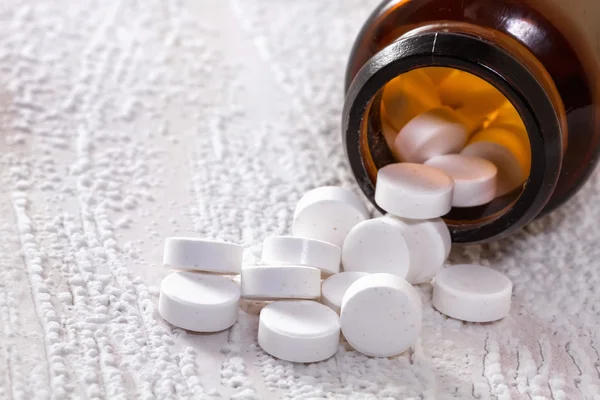 Pills in medical bottle on the table. — Stock Photo, Image