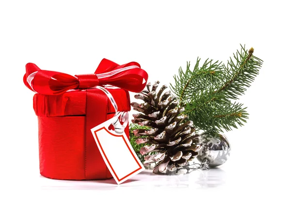 Red gift with Christmas tree branch. Isolate on white background — Stock Photo, Image