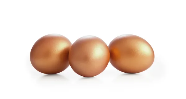 Golden eggs on white background. — Stock Photo, Image