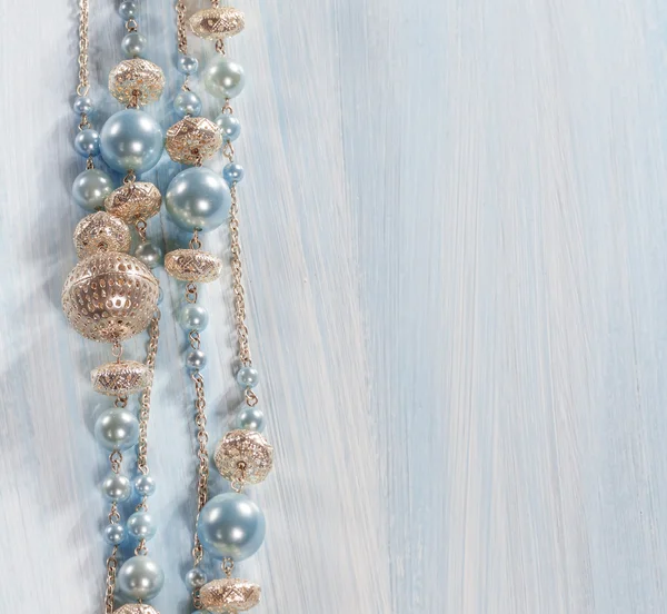 Blue beads on a wooden background — Stock Photo, Image