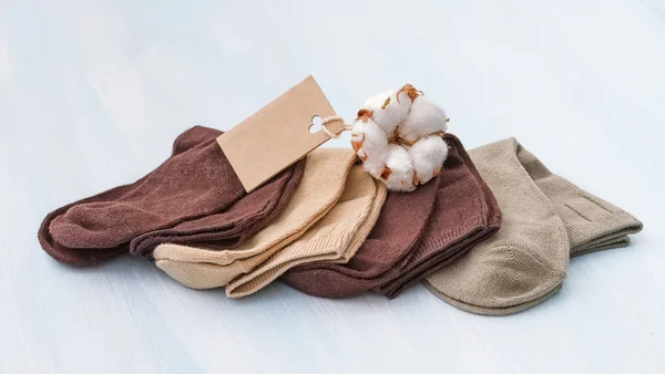Cotton socks with a sprig of cotton. — Stock Photo, Image