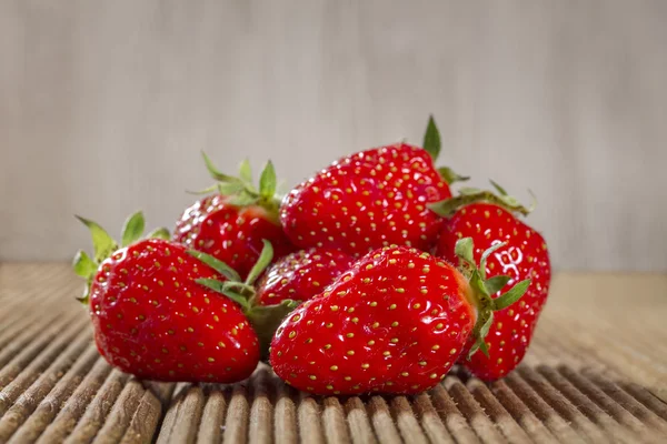 Ripe strawberry on a wooden background — Stock Photo, Image