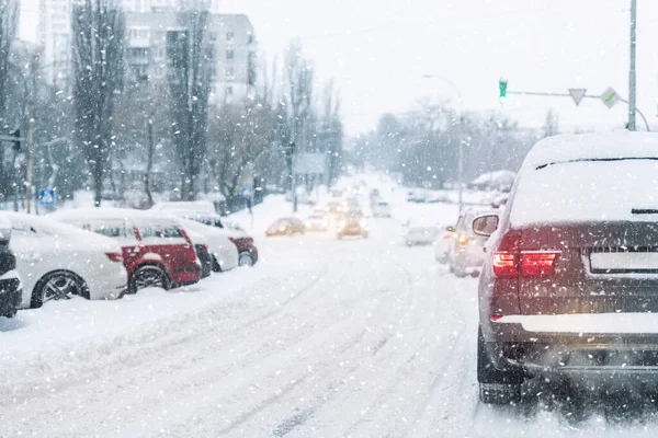 Szcenírozott nézet közlekedési dugó kereszteződésben sáros hó fedett csúszós közúti meghajtó lassú mozgó autók beragadt. Hóesés veszély hóvihar rossz téli időjárás. Városi hideg köd nap snowstrom város háttér — Stock Fotó