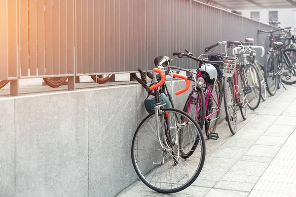 Closeup view many city bikes parked in row at european city street rental parking sharing station or sale. Healthy ecology urban transportation. Sport environmental transport infrastructure.