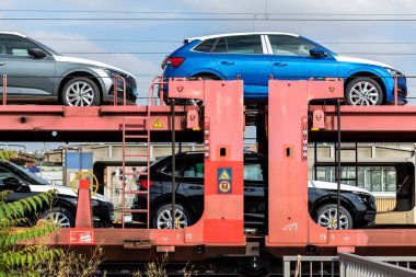 Mane new modern electric and fuel cars transportation by cargo freight train railway wagon. Railroad export and import automotive logistics service. Safety and insurance goods shipping insdustry.