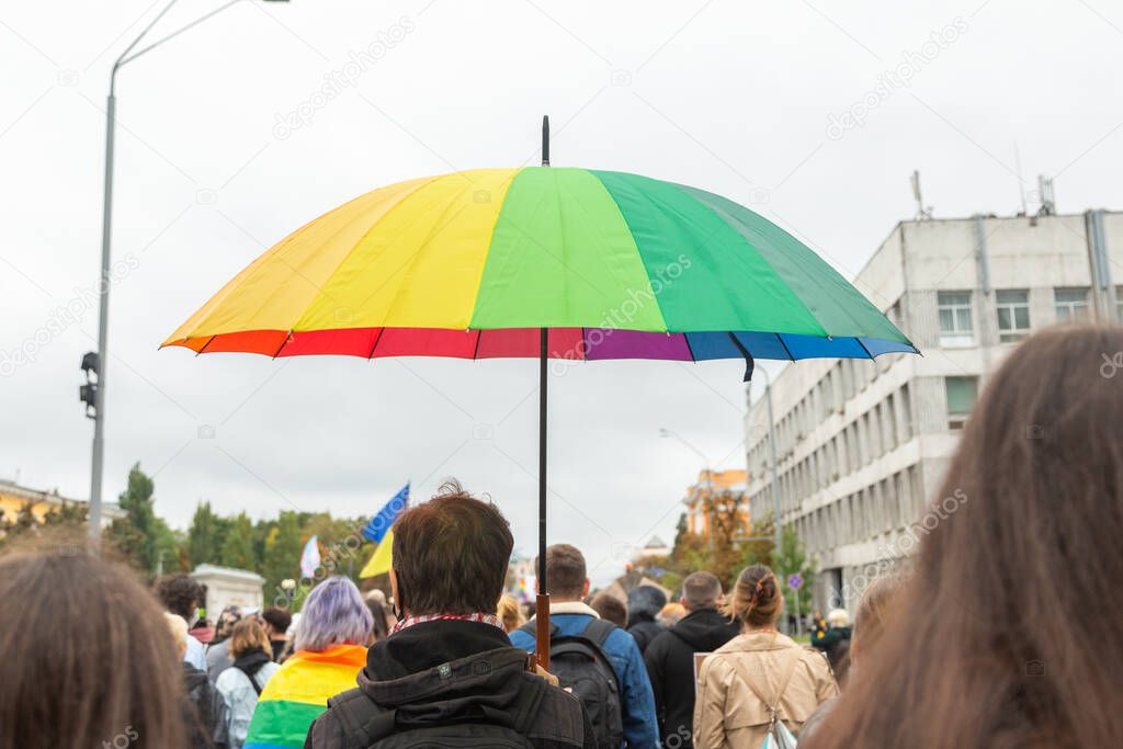 Pride Parade in the Kyiv, Ukraine. A rainbow-colored umbrella in the participant's hand of a march. Concept LGBTQ.