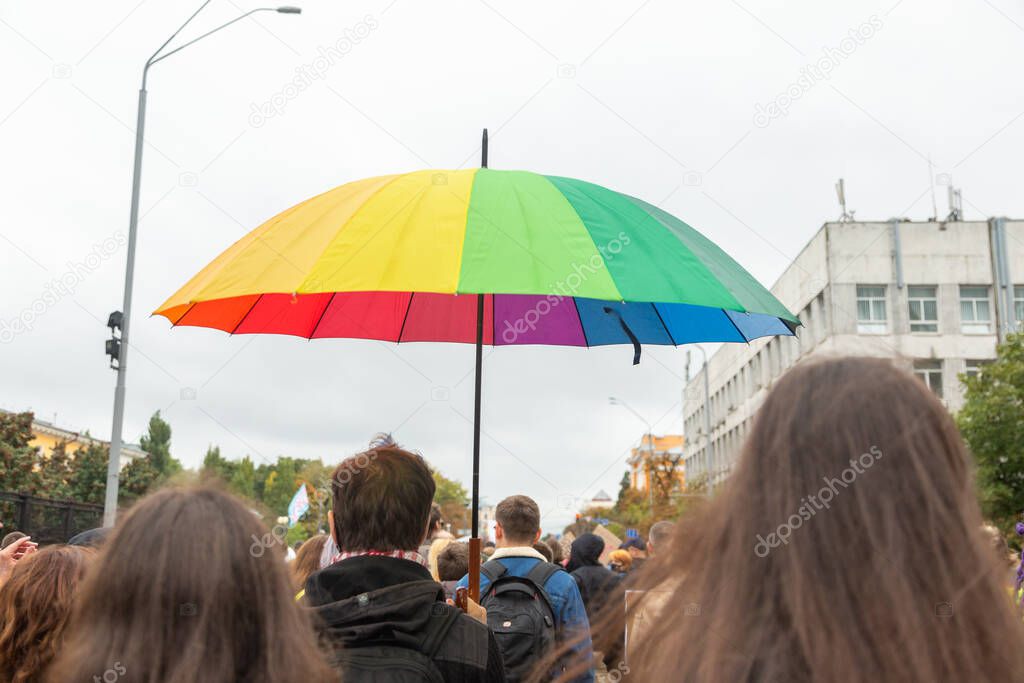 Pride Parade in the Kyiv, Ukraine. A rainbow-colored umbrella in the participant's hand of a march. Concept LGBTQ.