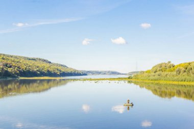 Shukhov 'un kulesi ufukta görünen Oka Nehri' ndeki balıkçı.