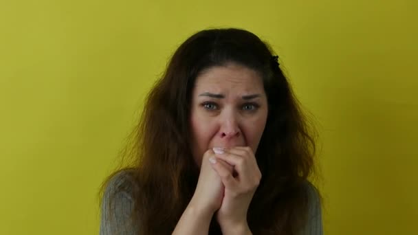 Beautiful grief-stricken woman biting her hands. — стоковое видео