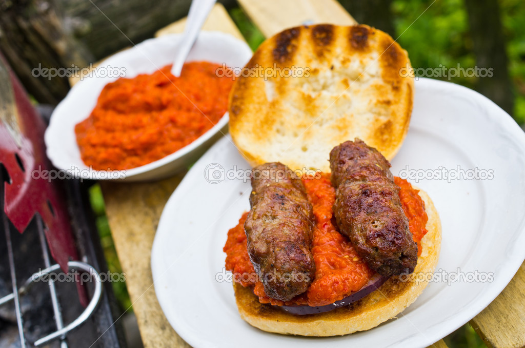 Cevapcici with ajvar in the grilled roll