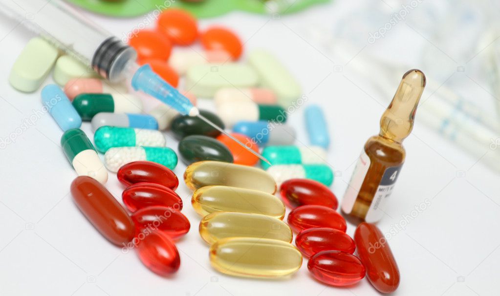 A macro shot of medicines, green capsules