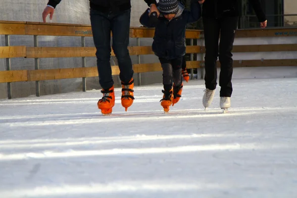 Feet with skates on an ice rink — Stock Photo, Image