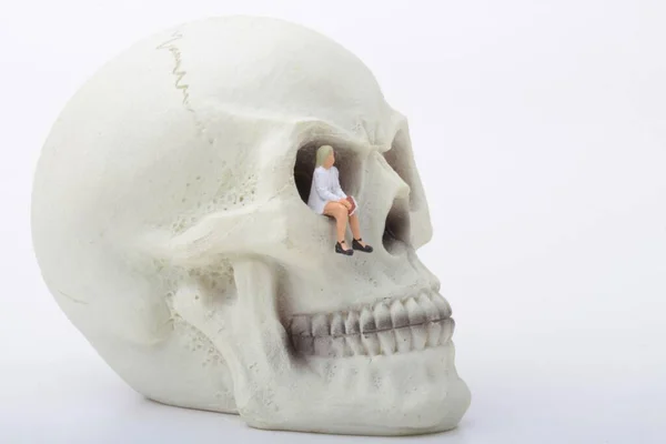 Miniature Figurine Woman Sitting Giant Human Skull — Stock Photo, Image