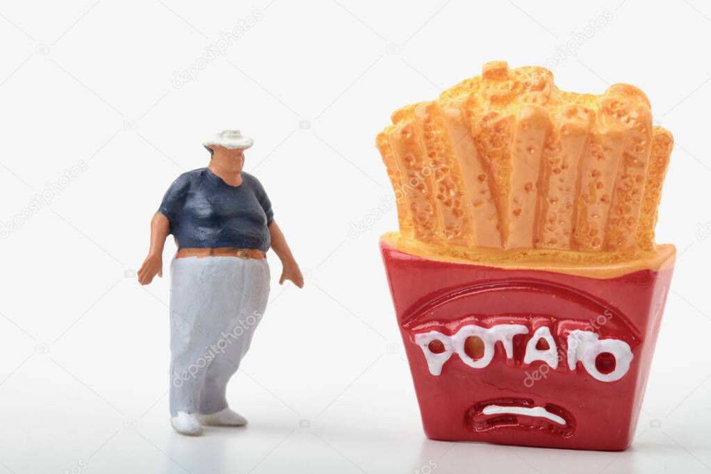 miniature figurine of a fat man with a giant box of french fries