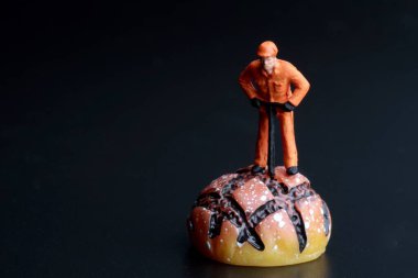 Bir somun ekmeği olan bir işçinin minyatür biblosu.