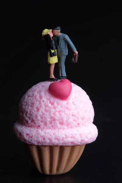 Figurine Miniatura Una Coppia Innamorati Baciati Con Dessert Gigante Sfondo — Foto Stock