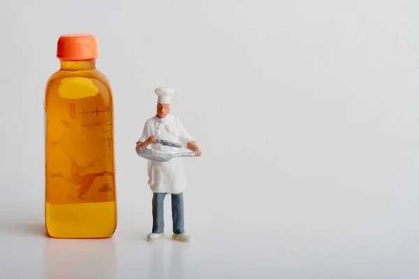 Miniature Figurine Chef Huge Bottle Oil White Background — 스톡 사진