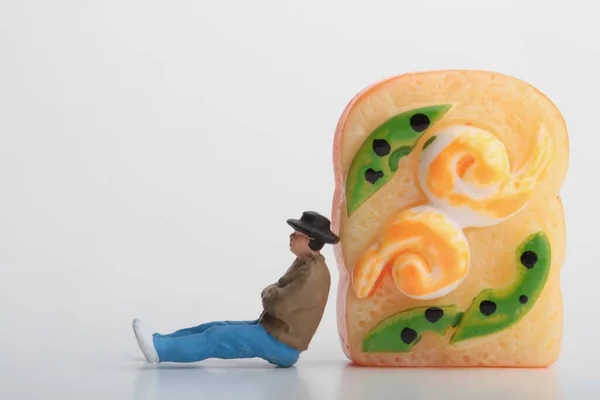 Miniature Figurine Man Leaning Huge Sandwich — Stockfoto
