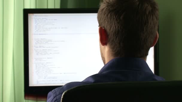 Young computer programmer at his desk — Stock Video