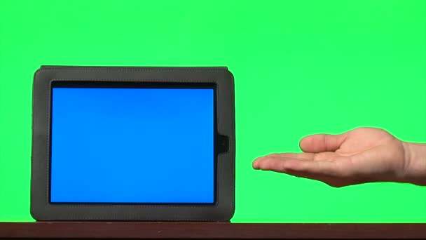 Man presenting digital tablet with a blue screen and gesturing — Stock Video