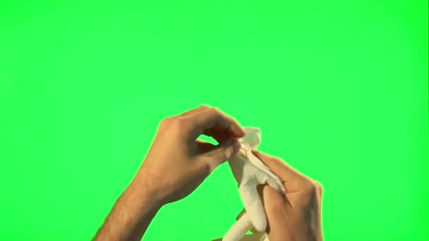 Man take off and puts on his surgical gloves - green screen — Stock Video