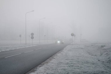 Riga, Latvia-October 6, 2021: Honda Civic 5DR making a turn on the foggy road during the cold autumn morning