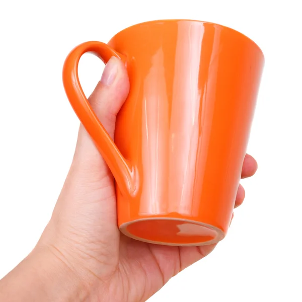 Женская рука с оранжевой чашкой — стоковое фото