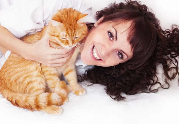 Joyful girl hugging red cat Stock Image