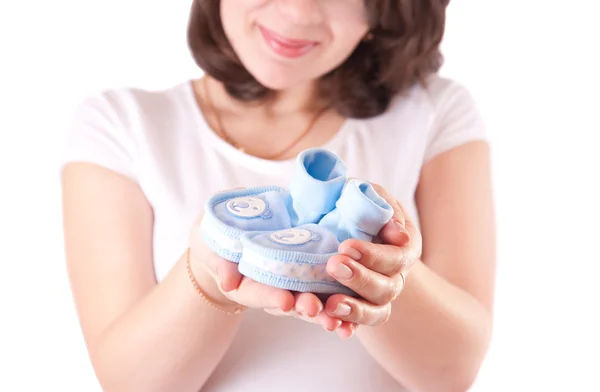 Woman hand with baby shoes — Stock Photo, Image