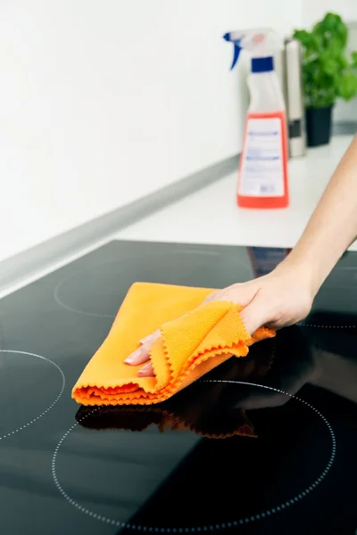 Hand cleaning induction stove — Stock Photo, Image