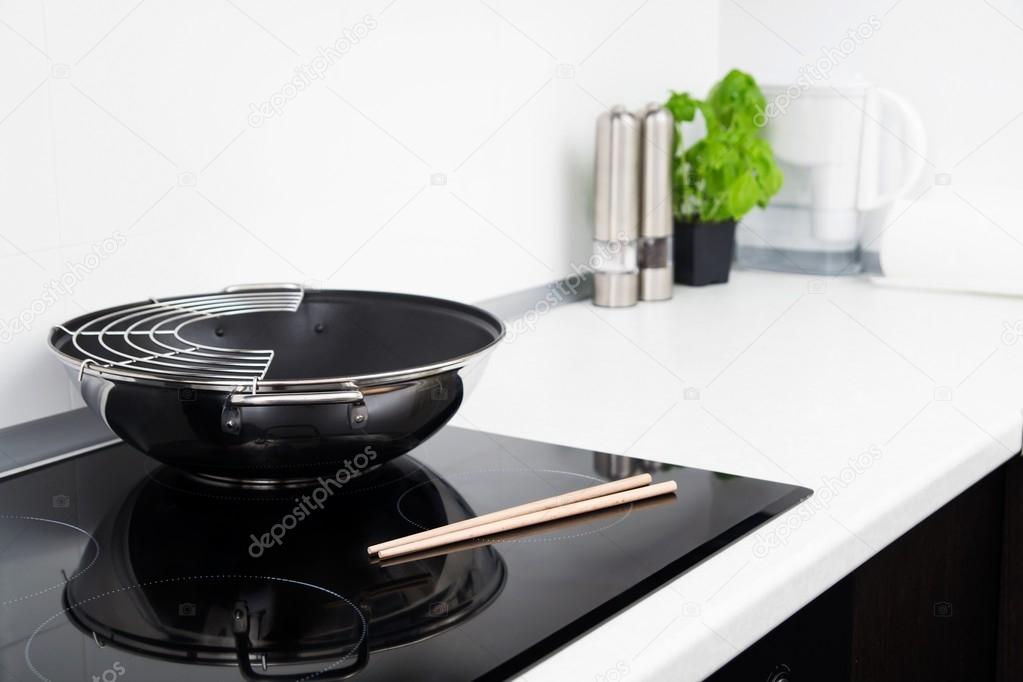 Frying pan and sticks in modern kitchen