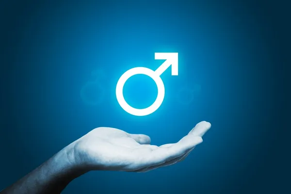 Shining male sex sign, man's hand on blue background — Stock Photo, Image
