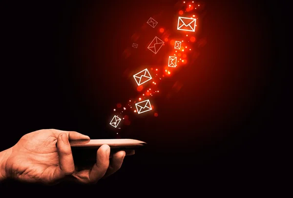 Abstract, touching mobile phone, flying envelopes, fire effect — Stock Photo, Image