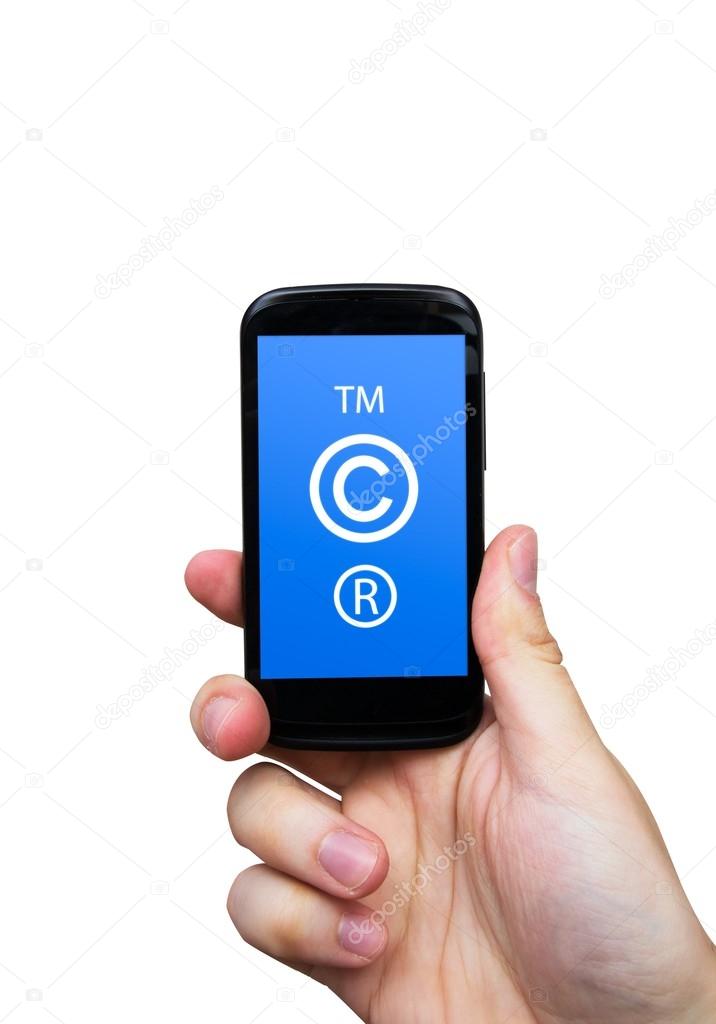 Copyright, trademark symbols on smart phone. Security and pirac