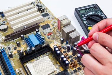 Motherboard measure. Man repairing computer hardware