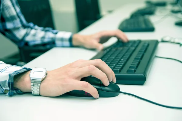 Jovem a escrever no teclado. Sala de treinamento com computadores — Fotografia de Stock