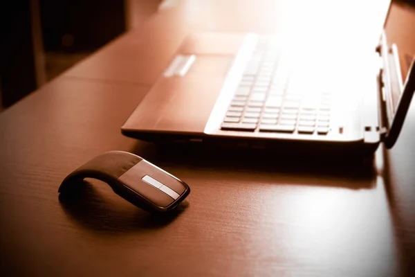 Human hand on computer mouse. Laptop on desk. — Stock Photo, Image