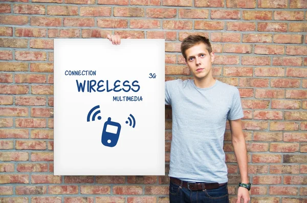 Young man holding whiteboard with multimedia content — Stock Photo, Image