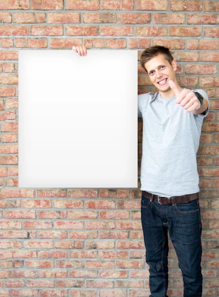 Young man holding blank whiteboard on business presentation — Stock Photo, Image