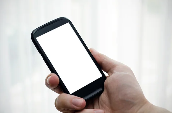 Mão segurando telefone celular com display em branco — Fotografia de Stock