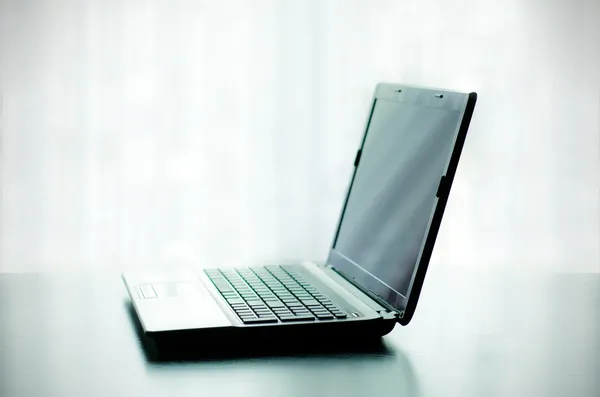 Modern laptop on desk — Stock Photo, Image