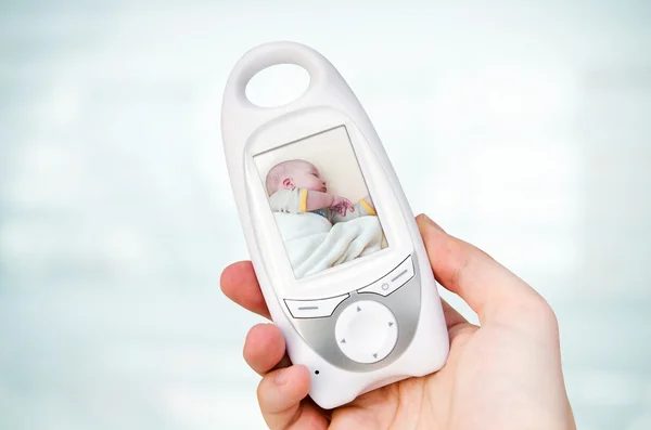 Hand holding video baby monitor for security of the baby — Stock Photo, Image