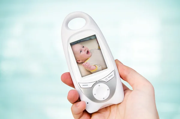 Hand holding video baby monitor for security of the baby — Stock Photo, Image